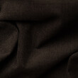 Closeup detail of brown crumpled fabric cloth texture background.