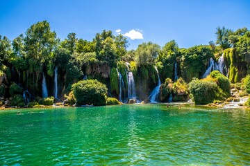 Wall Mural - Breathtaking view of Kravica Waterfall cascading down the Trebizat River in Bosnia and Herzegovina.