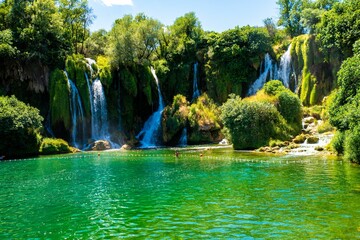 Wall Mural - Breathtaking view of Kravica Waterfall cascading down the Trebizat River in Bosnia and Herzegovina.