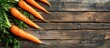 A bunch of fresh organic carrots neatly arranged on top of a rustic wooden table.