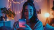 Portrait of smiling young woman using mobile phone in bed at home