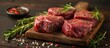 A wooden cutting board topped with fresh raw beef steaks, ready for cooking or preparation.