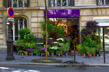Fototapeta Paryż - Street with flower shop in Paris, France. Cozy cityscape of Paris. Architecture and landmarks of Paris.