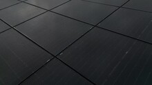 Closeup Drone Shot Of Solar Panels With Rain Drops On A White Building Roof On A Cloudy Day