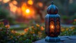 In the spirit of Ramadan Kareem, an Arabic lantern with a burning candle shines at night during the Muslim holy month of Ramadan Kareem