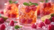  A close-up photograph of an ice tea glass with raspberries on the rim and mint garnish