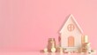 House and stacking coins and banknotes on pink background
