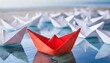 Red paper boat sails ahead of white paper boats which is a symbol of leadership concep