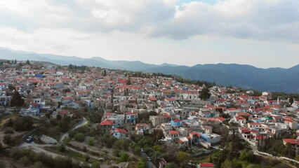 Wall Mural - Aerial view popular tourist attraction Pano Lefkara village on Cyprus, Europe. Flying over majestic cityscape with greek orthodox church on the beautiful green hills