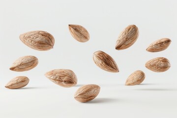 Almonds hover over a white background. Millenistic concept of stone fruit.