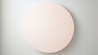 A single, imperfect circle in a muted pastel shade against a crisp white background, evoking a sense of serenity and simplicity
