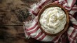 Overhead shot of natural yogurt in a round bowl with a country-style red and white napkin