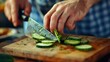 A person slicing cucumbers on a wooden cutting board. Suitable for culinary and healthy eating concepts