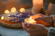 a person's hands lighting a scented candle, setting the mood for a calming and rejuvenating aromatherapy session