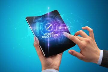 Poster - Businessman holding a foldable smartphone, technology concept