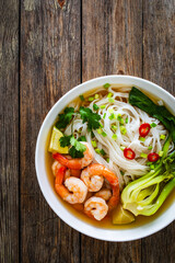 Poster - Shrimp Pho soup - Vietnamese soup with shrimps on wooden table
