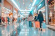Abstract blurred shopping mall with motion blurred shoppers and modern architecture
