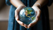 Woman's hands holding a planet earth