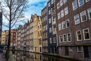 Wall Mural - Amsterdam downtown - Amstel river, old houses and a bridge. Travel to Europe. Holland, Netherlands, Europe.