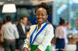 Vibrant Professional at Corporate Event. Joyful African American woman with a badge at a business conference.