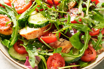 Wall Mural - Green salad with baked chicken breast, fresh salad leaves and vegetables.