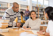 © JackF - Group of young adult multiracial people studying in library, talking, reading books and writing in notepads