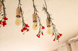 Red carnations are attached to lamps on the ceiling, diagonally across the frame. Bottom view