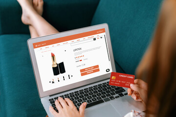 Woman shopping online on internet marketplace browsing for sale items for modern lifestyle and use credit card for online payment from wallet protected by utmost cyber security software