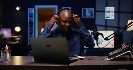 Wall Mural - Portrait of african american man starting live broadcast on streaming platform, greeting viewers. Cheerful internet star arriving in studio, ready to create content for his audience