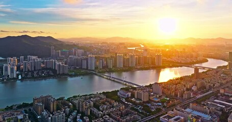 Canvas Print - Aerial forward shot of modern city skyline and river nature landscape of Zhuhai at sunset