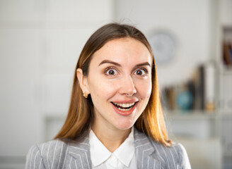 Wall Mural - Portrait of surprised young caucasian woman office worker.