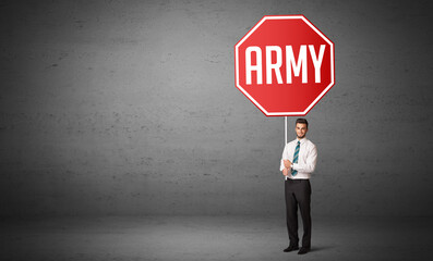 Wall Mural - Young business person holding road sign