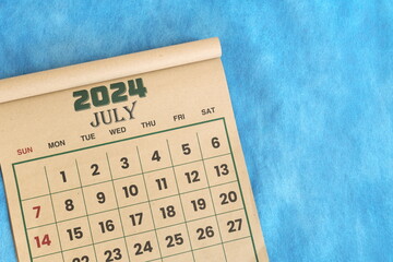 Wall Mural - July 2024 calendar flat lay in blue background with copy space.