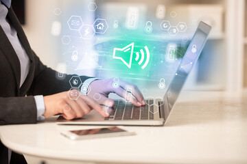 Canvas Print - Hands working on laptop with digital icons