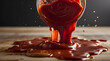 Thick, rich tomato sauce drizzles onto crunchy biscuits spread on a wooden table, capturing a dynamic food moment