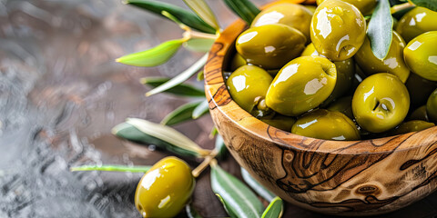 a  wooden bowl of green olives with leaves, generative AI