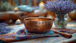 A shallow copper bowl with dried lavender in the background on a complex table. Tibetan bell-shaped copper bowl with engravings on the piece.