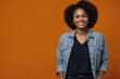 © Cristian - African-american woman with smile on face next to empty space on orange dot background for advertising campaigns. Young handsome man indicating place for advertising text in studio.