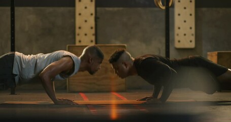 Poster - Man, fitness and team in push ups for workout, exercise or strength training together on floor at gym. Male person, personal trainer or friends touching hands and lifting body weight at health club