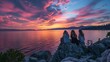 A small group of friends sit on a rocky outcropping backs facing the camera as they marvel at the striking colors of the sky . .