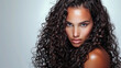 © JuanM - Beauty portrait of a young Indian woman with curly hair isolated from a white copyspace background