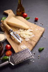 Wall Mural - Piece of Traditional Italian Parmesan Hard cheese on a wooden cutting board at domestic kitchen