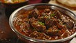 A flavorful plate of bhuna gosht, showcasing tender pieces of mutton or beef cooked with tomatoes, onions, ginger, garlic, and a blend of aromatic spices, served with naan or tandoori roti.