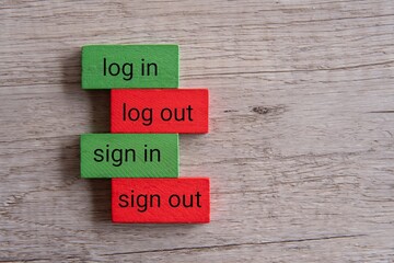 Wall Mural - Top view image of wooden blocks with text LOG IN, LOG OUT, SIGN IN, SIGN OUT.