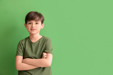 Wall Mural - Little boy on green background. Children's Day celebration