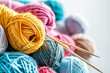 Colorful knitting yarn with needles on a white background, representing needlework and a hobby