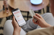 © AnnaStills - High angle view of unrecognizable young woman holding blister with birth control pills and checking period calendar on smartphone