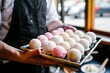 server holding a platter of mochi ice cream balls