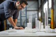 architect reviewing skyscraper models on construction site table