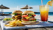 Delicious hamburgers with beef, tomato, cheese, lettuce chips and a cool drink at the beach
